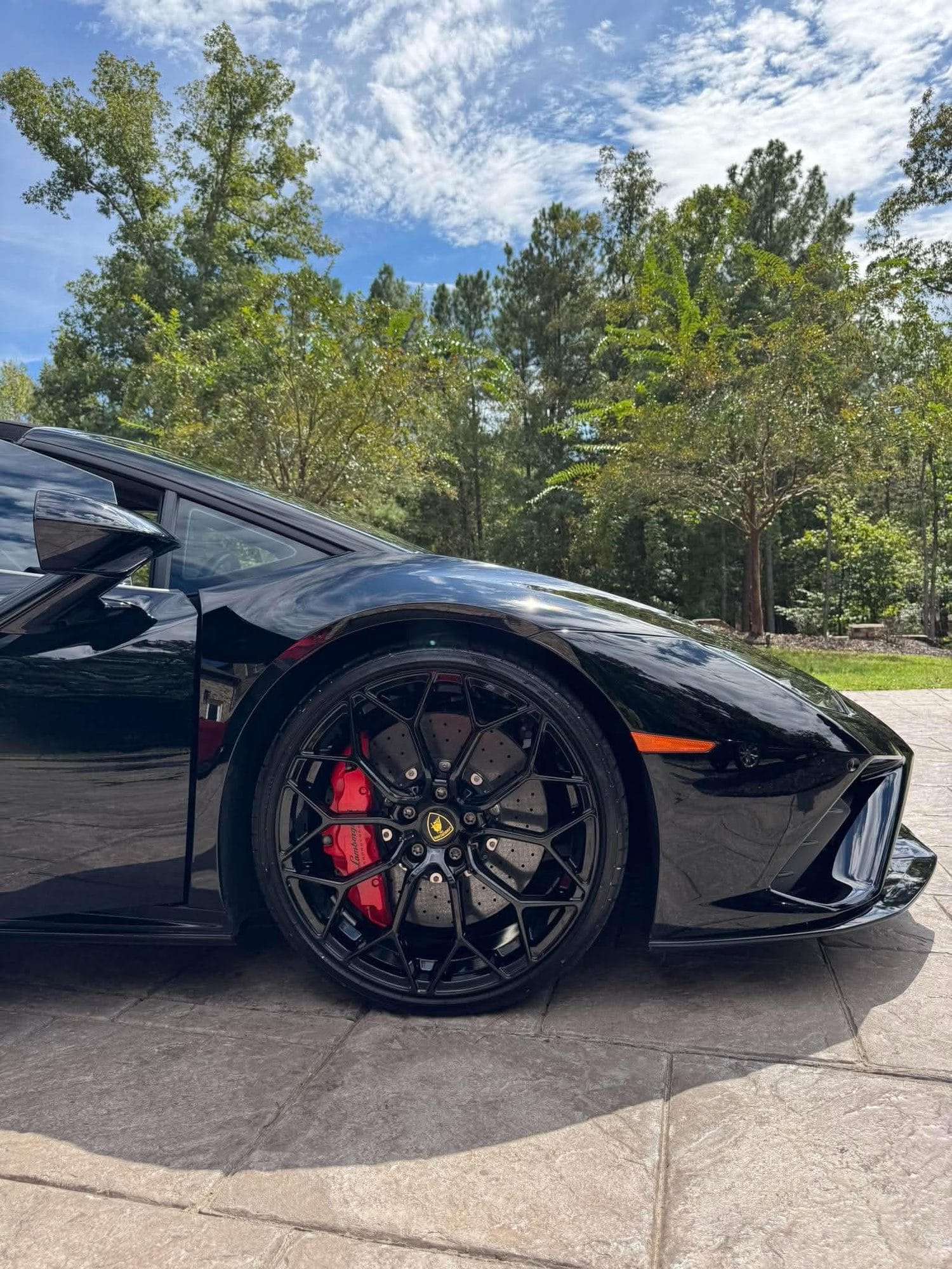 Lamborghini wheel and red brake caliper after cleaning